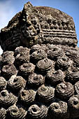 Candi Panataran - Main Temple. Back side of one of the giant guardians to left of the staircase of the temple with detail of the elaborately curled coiffure. 